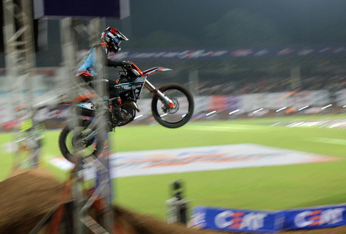 Motocross racer flying at the finish line 