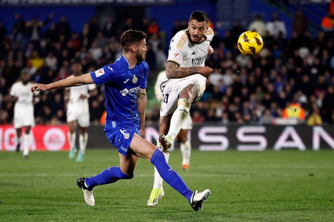Getafe's Domingos Duarte tries to block Real Madrid's Joselu as he nets the goal 