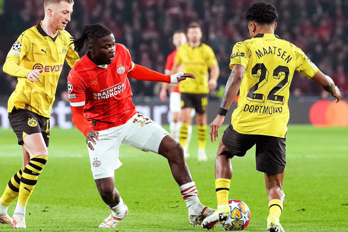 PSV's Johan Bakayoko is challenged by Dortmund players 