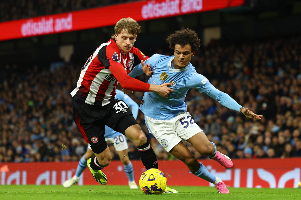 Brentford's Mads Roerslev challenges Manchester City's Oscar Bobb