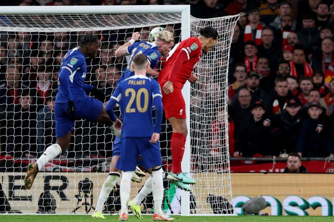 Liverpool's Virgil van Dijk scores off a header