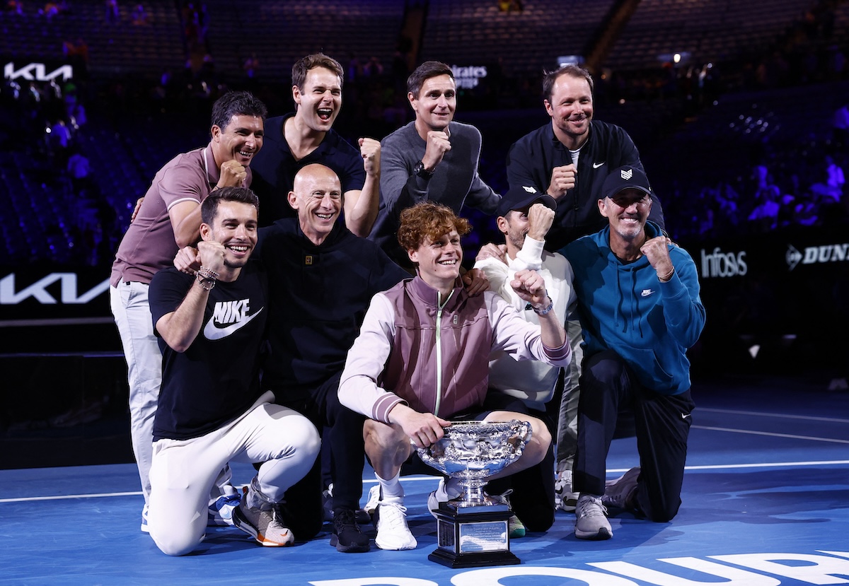 Jannik Sinner poses for a picture with coaches Darren Cahill and Simone Vagnozzi, physio Giacomo Naldi and fitness coach Umberto Ferrara after winning the 2024 Australian Open