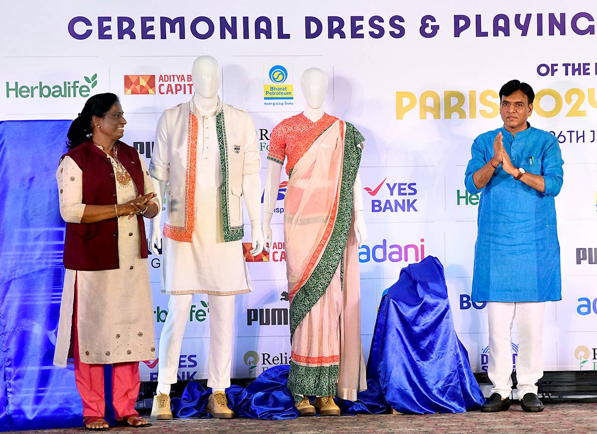 Union Sports and Youth Affairs Minister Mansukh Mandaviya and Indian Olympic Association (IOA) President PT Usha unveils the ceremonial dress designed by TASVA owner Tarun Tahiliani (unseen) 