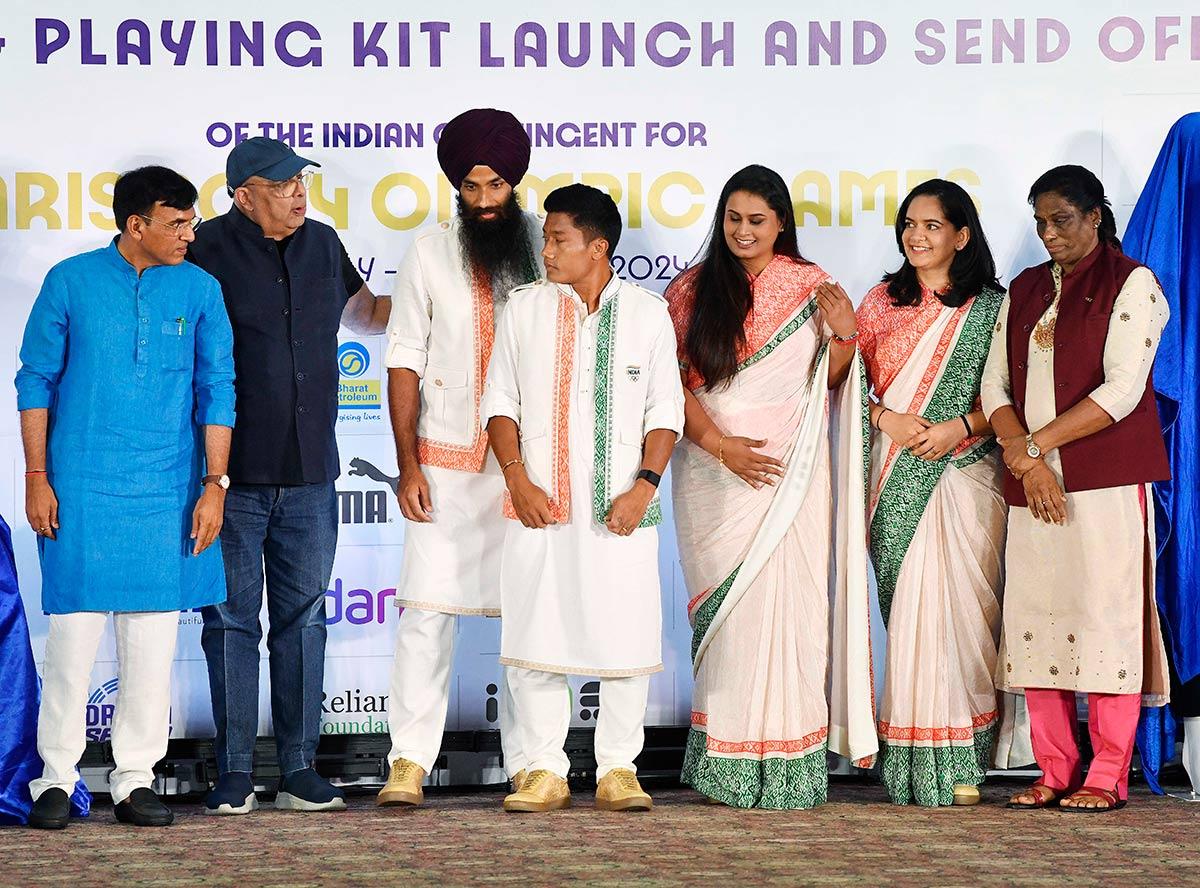 Union Sports and Youth Affairs Minister Mansukh Mandaviya, Indian Olympic Association (IOA) President PT Usha and TASVA owner Tarun Tahiliani during the unveiling of the ceremonial dress