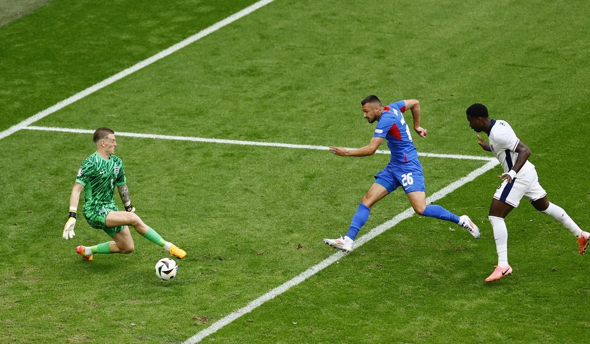 Ivan Schranz places the ball past England's goalkeeper Jordan Pickford to put Slovakia into the lead.