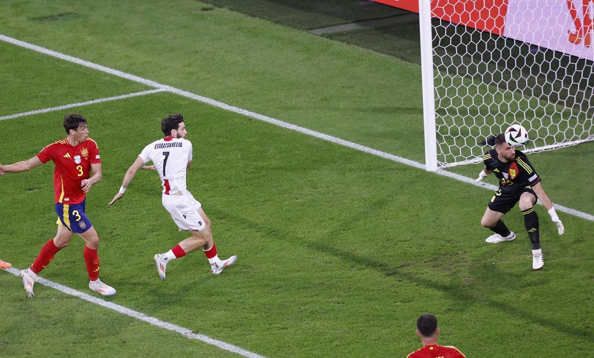 Spain's goalkeeper Unai Simon watches helplessly as a shot from Georgia's Otar Kakabadze strikes Robin Le Normand and goes into his own net.