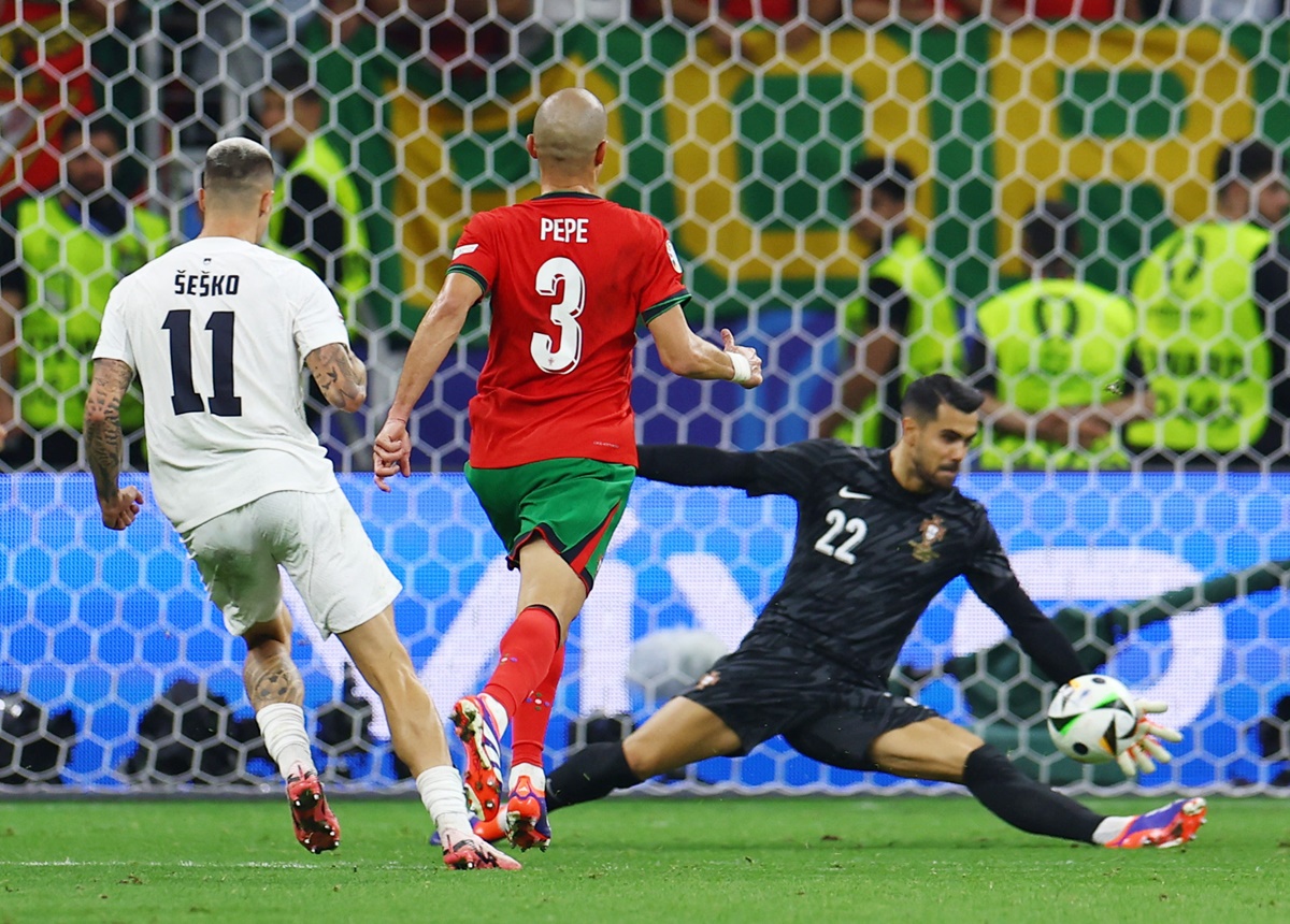Portugal's goalkeeper Diogo Costa does well to save a shot from Slovenia's Benjamin Sesko in extra-time.