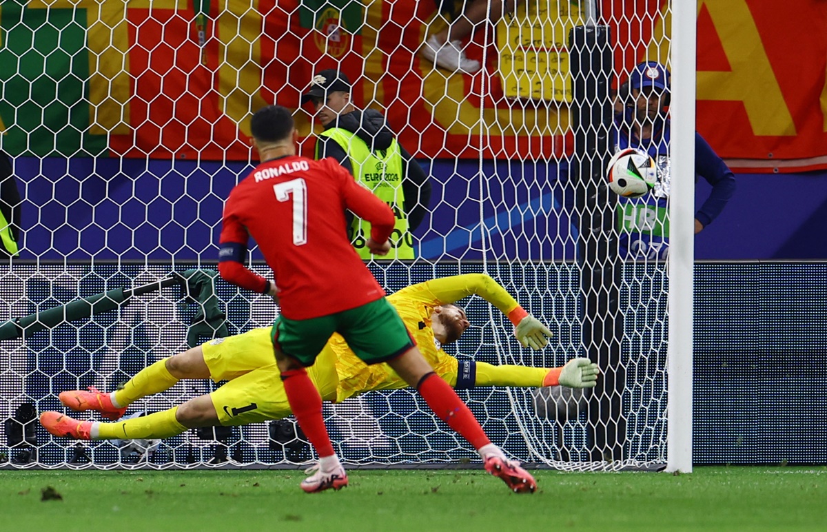Slovenia's goalkeeper Jan Oblak saves a penalty from Portugal's Cristiano Ronaldo in extra-time.