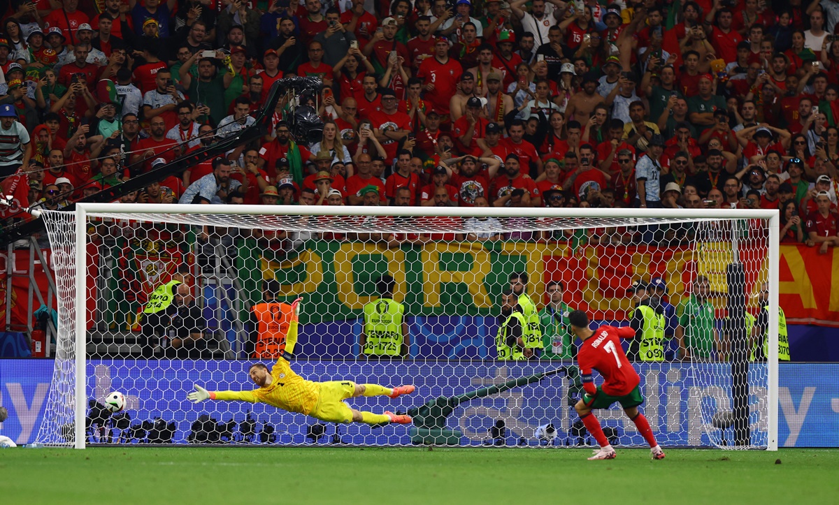 Cristiano Ronaldo beats Slovenia's goalkeeper Jan Oblak in the penalty shoot-out.