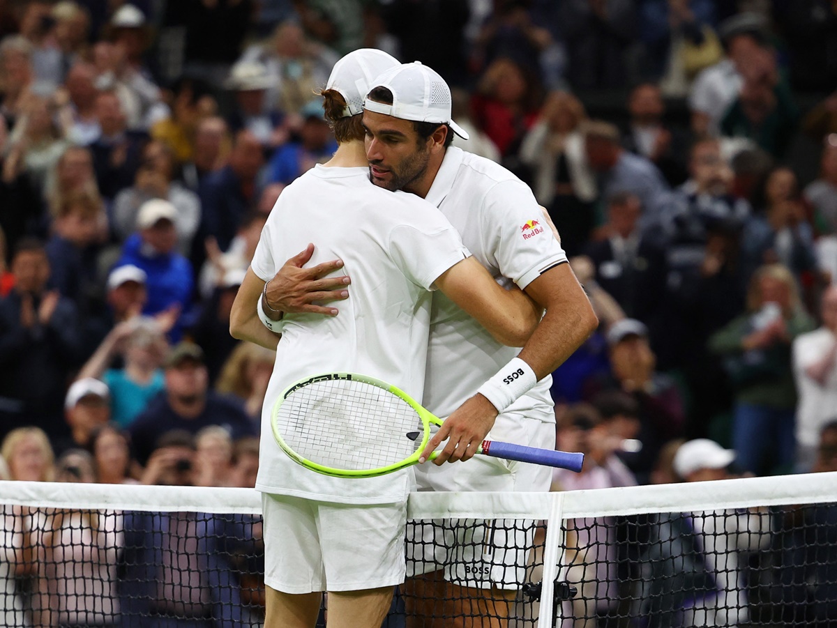 Jannik Sinner embraces his friend and compatriot Matteo Berrettini warmly after the match.