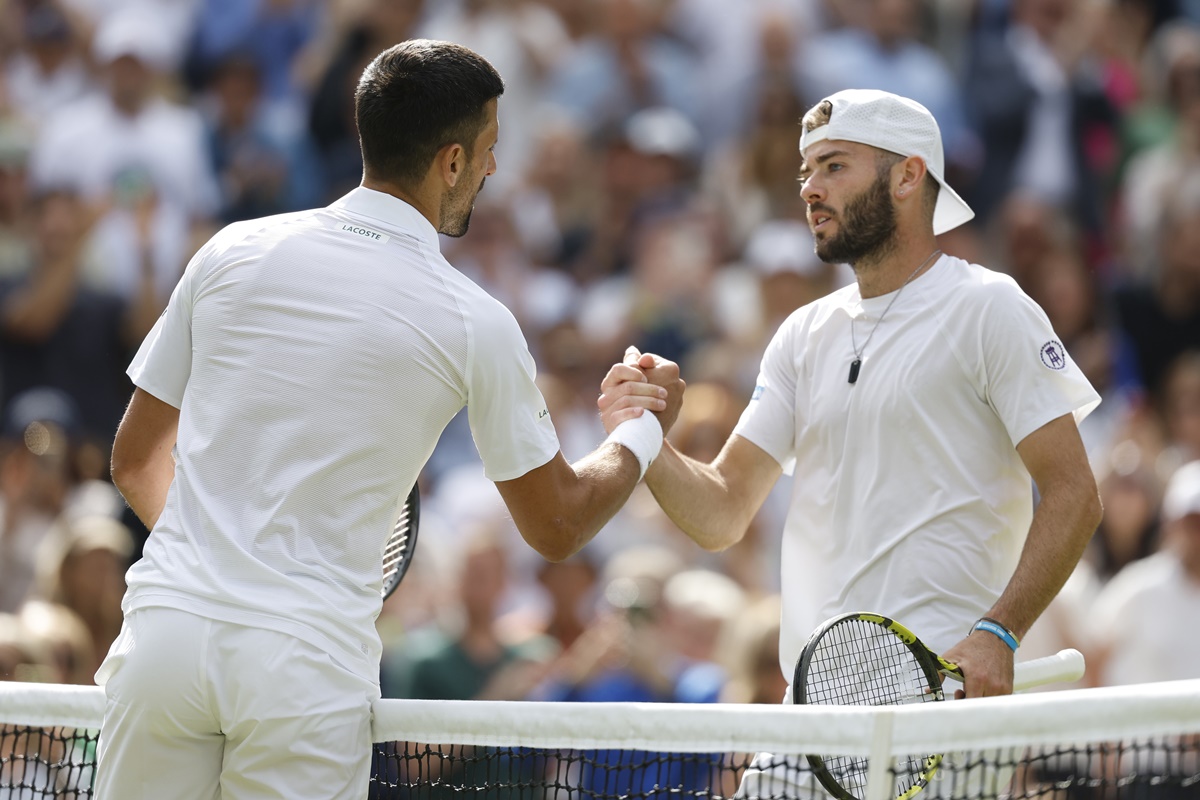 Novak Djokovic congratulates Jacob Fearnley on 'an amazing match' at the net.