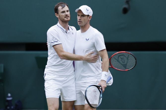 Andy Murray (right) hugs brother Jamie Murray after their Wimbledon doubles match against Australia's Rinky Hijikata and John Peers at the All England Lawn Tennis and Croquet Club, London, on Thursday.