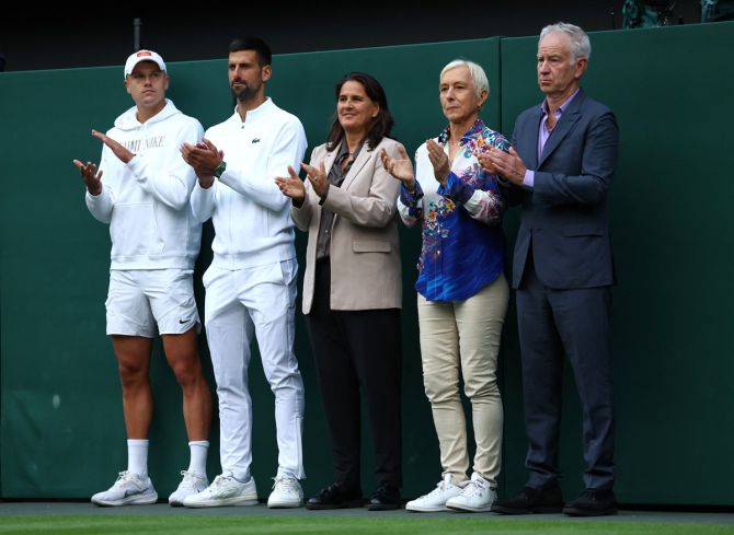 Novak Djokovic, Denmark's Holger Rune and former tennis players John McEnroe, Martina Navratilova and Conchita Martinez applaud Andy Murray on court.