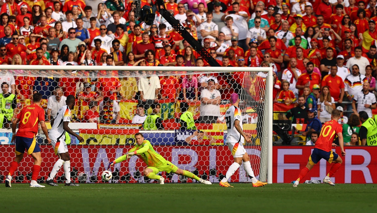 Dani Olmo fires the ball from the top of the box past Germany's goalkeeper Manuel Neuer to put Spain ahead in the match.