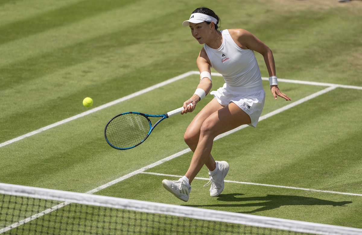 China's Xinyu Wang returns a shot during her match against Jessica Pegula of the United States.