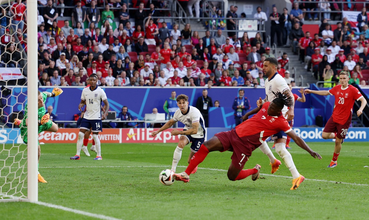 Breel Embolo sends the ball past England goalkeeper Jordan Pickford to put Switzerland ahead in the match.