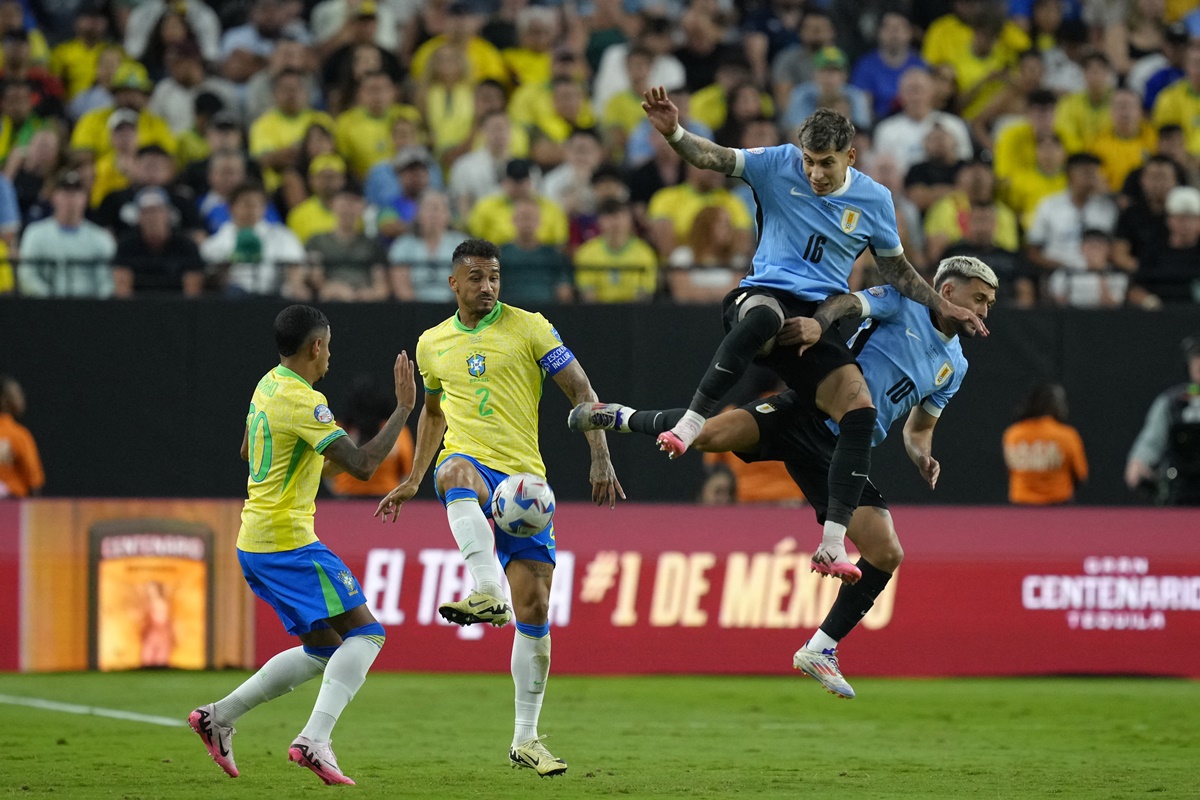 Brazil defender Danilo (No. 2) clears the ball as Uruguay defender Mathias Olivera (No. 16) and midfielder Giorgian de Arrascaeta (No. 10) try to break through.