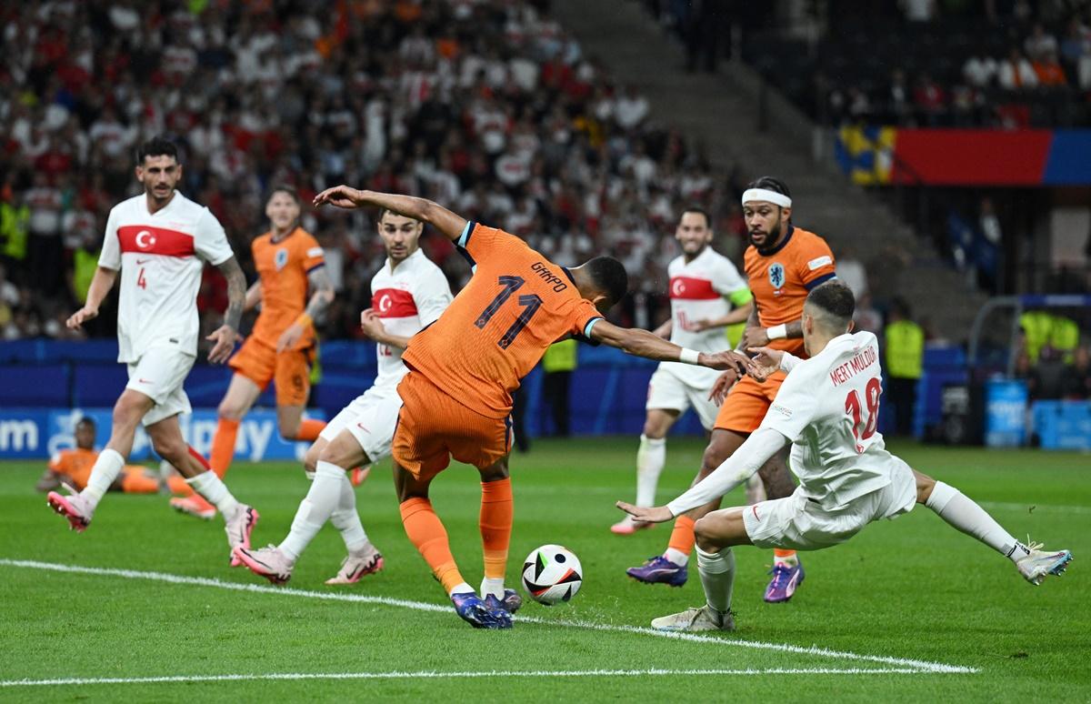 Turkey defender Mert Muldur deflects the ball into his own net under pressure from the Netherlands's Cody Gakpo during the Euro 2024 quarter-final between the Netherlands and Turkey, at Berlin Olympiastadion, Germany, on Saturday.