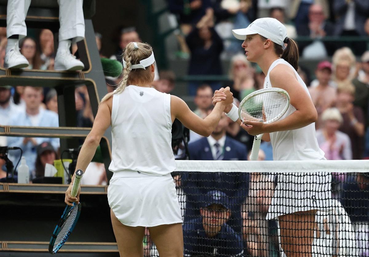 Yulia Putintseva shakes hands with Iga Swiatek at the net after her third round match.