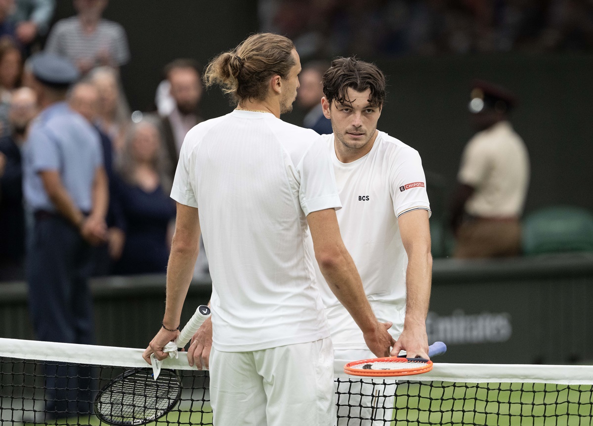 Taylor Fritz empathises with Alexander Zverev at the net after the match.