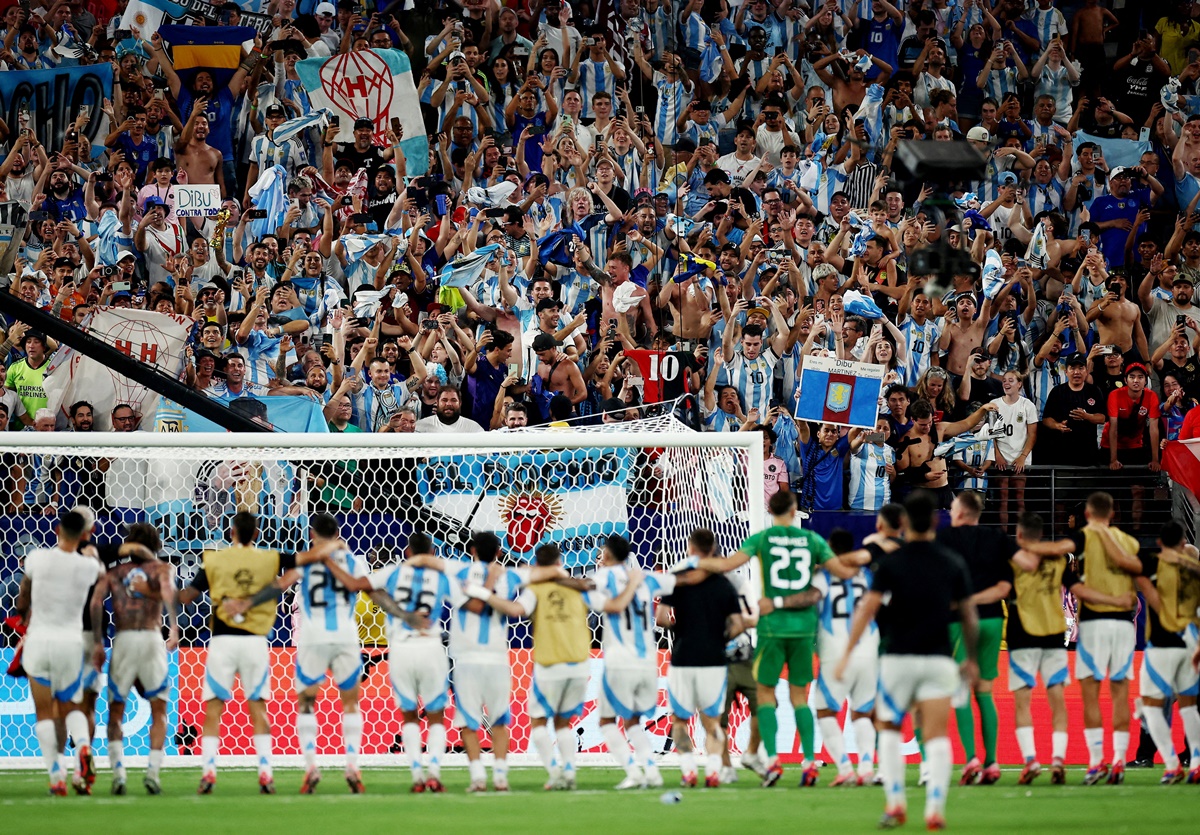 Argentina players celebrate with fans after the match.