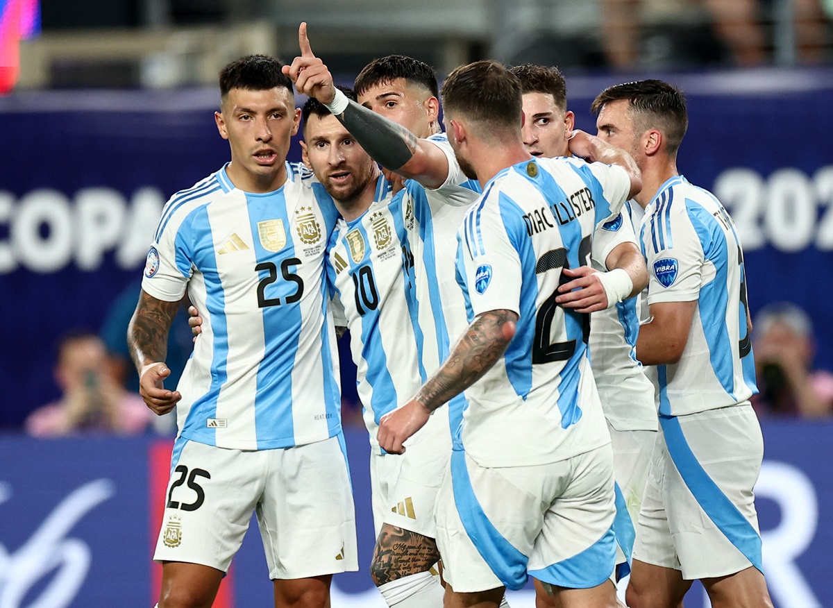 Argentina players await the VAR decision for off-side after Lionel Messi scores their second goal.