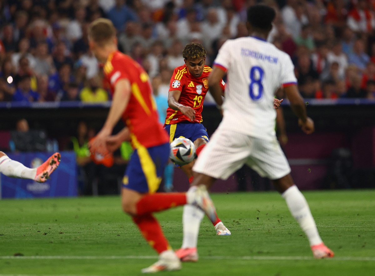 Lamine Yamal curls the ball with a left-footer to the corner of the France goal for Spain's first goal.