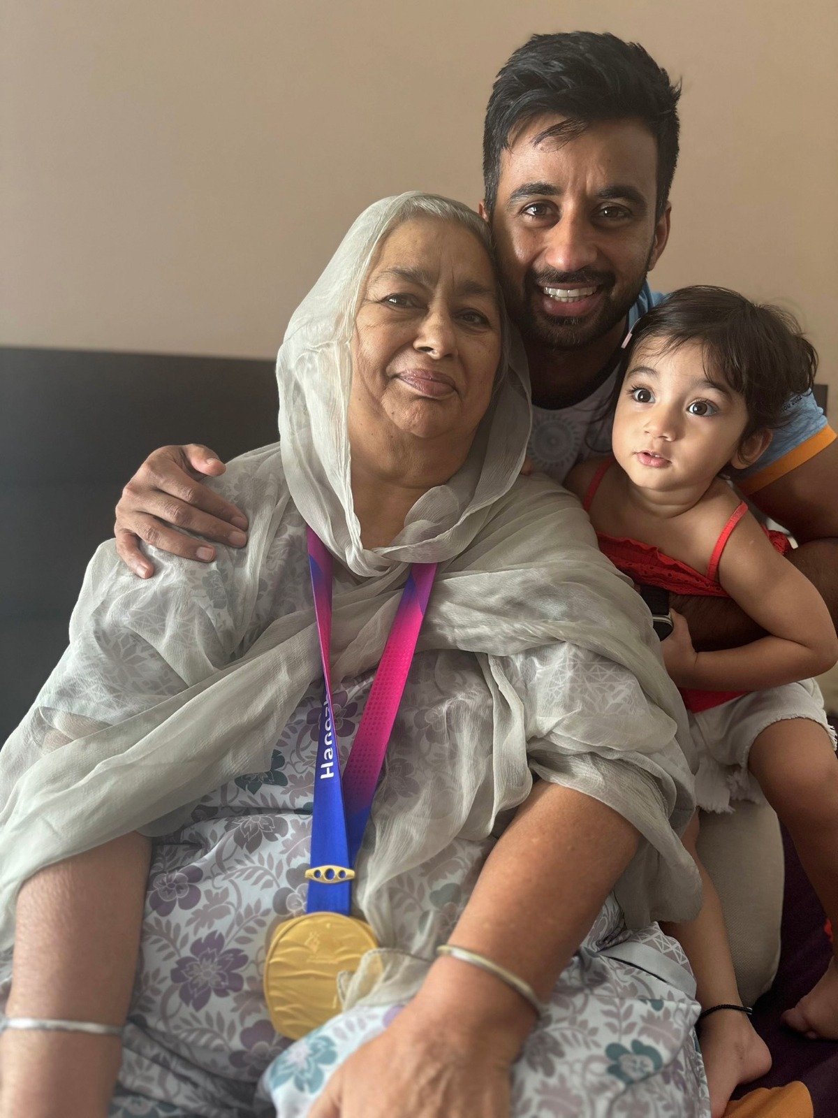 Hockey player Manpreet Singh with his mother after winning the Asian Games gold medal in 2023