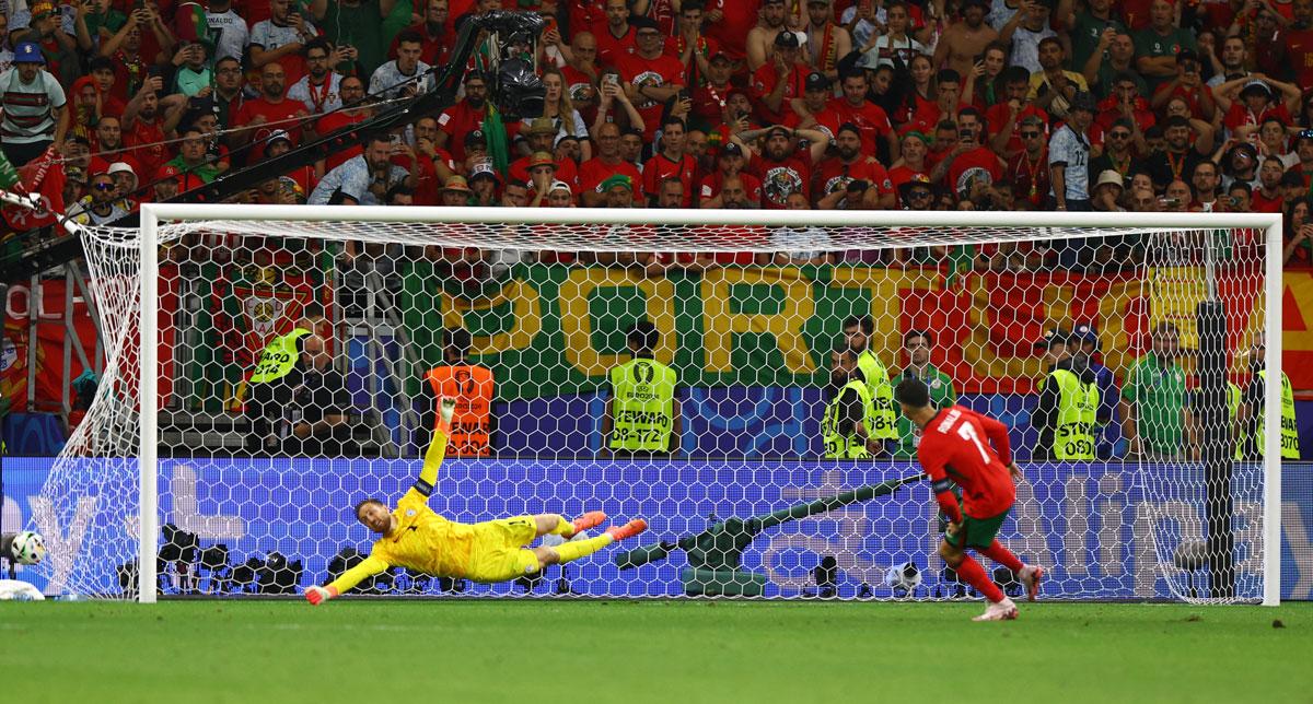 Cristiano Ronaldo successfully scores during the penalty shoot-out.