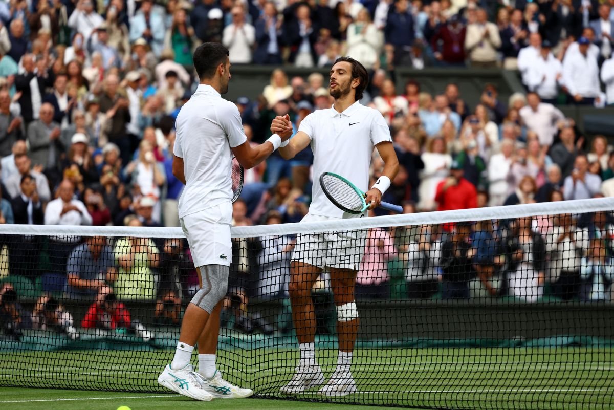 Lorenzo Musetti congratulates Novak Djokovic after their men's singles semi-final on Friday.