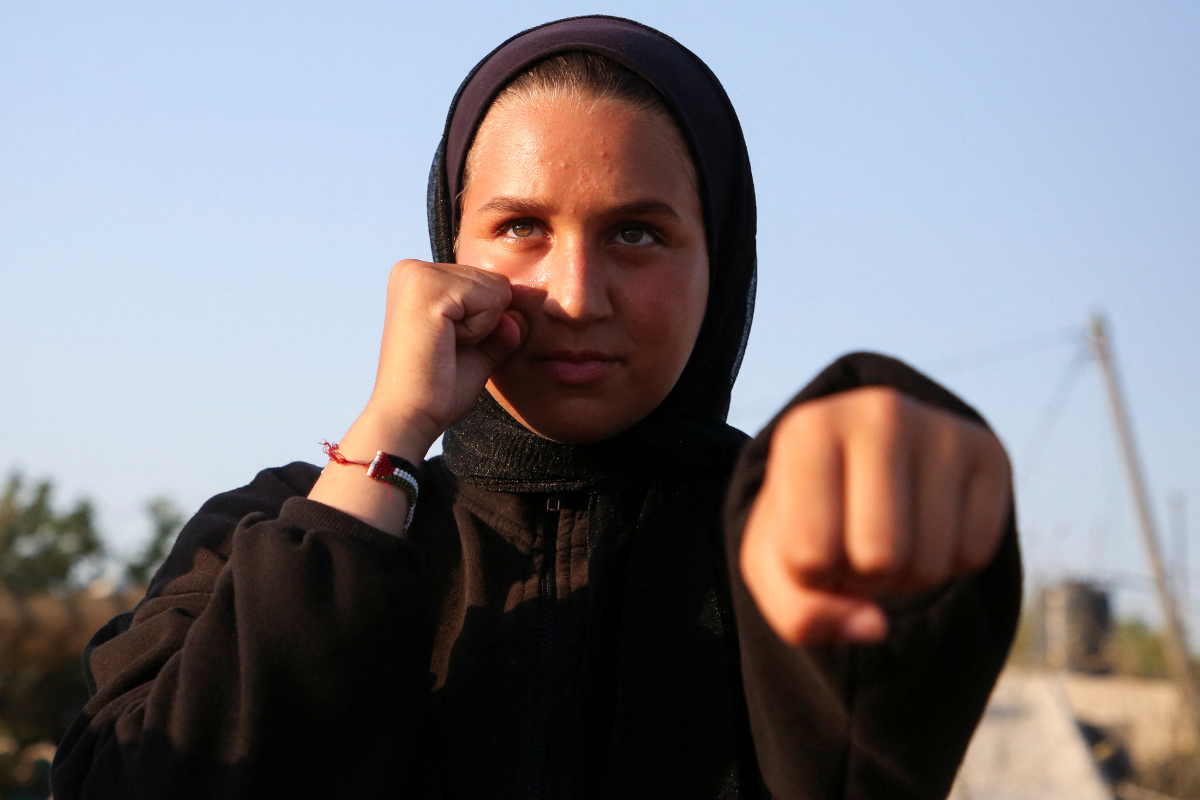 A girl trains for boxing under Palestinian boxing coach Osama Ayoub near a tent camp sheltering displaced people, amid the Israel-Hamas conflict, in Khan Younis in the southern Gaza Strip, on July 10, 2024. 