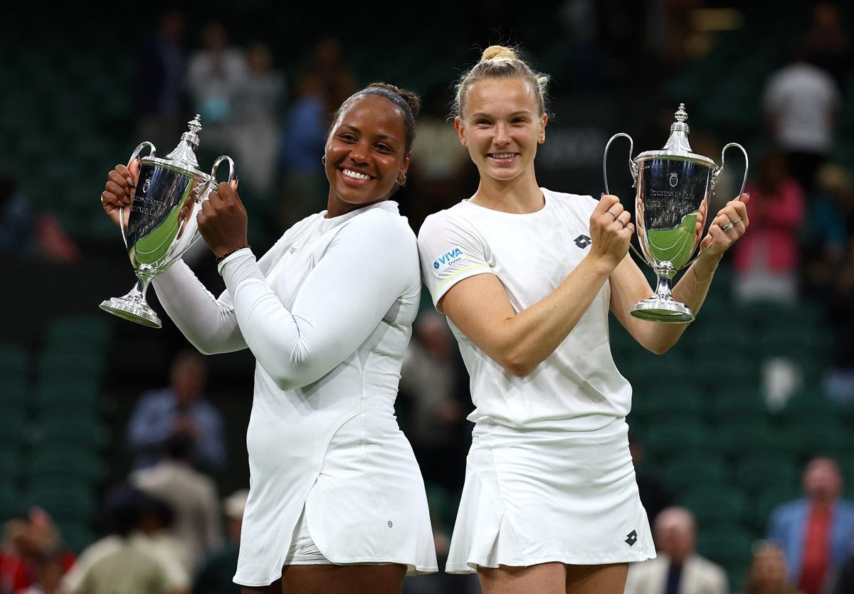 Taylor Townsend of the United States and the Czech Republic's Katerina Siniakova celebrate with their trophies after winning the Wimbledon Championships women's doubles final against Canada's Gabriela Dabrowski and New Zealand's Erin Routliffe.