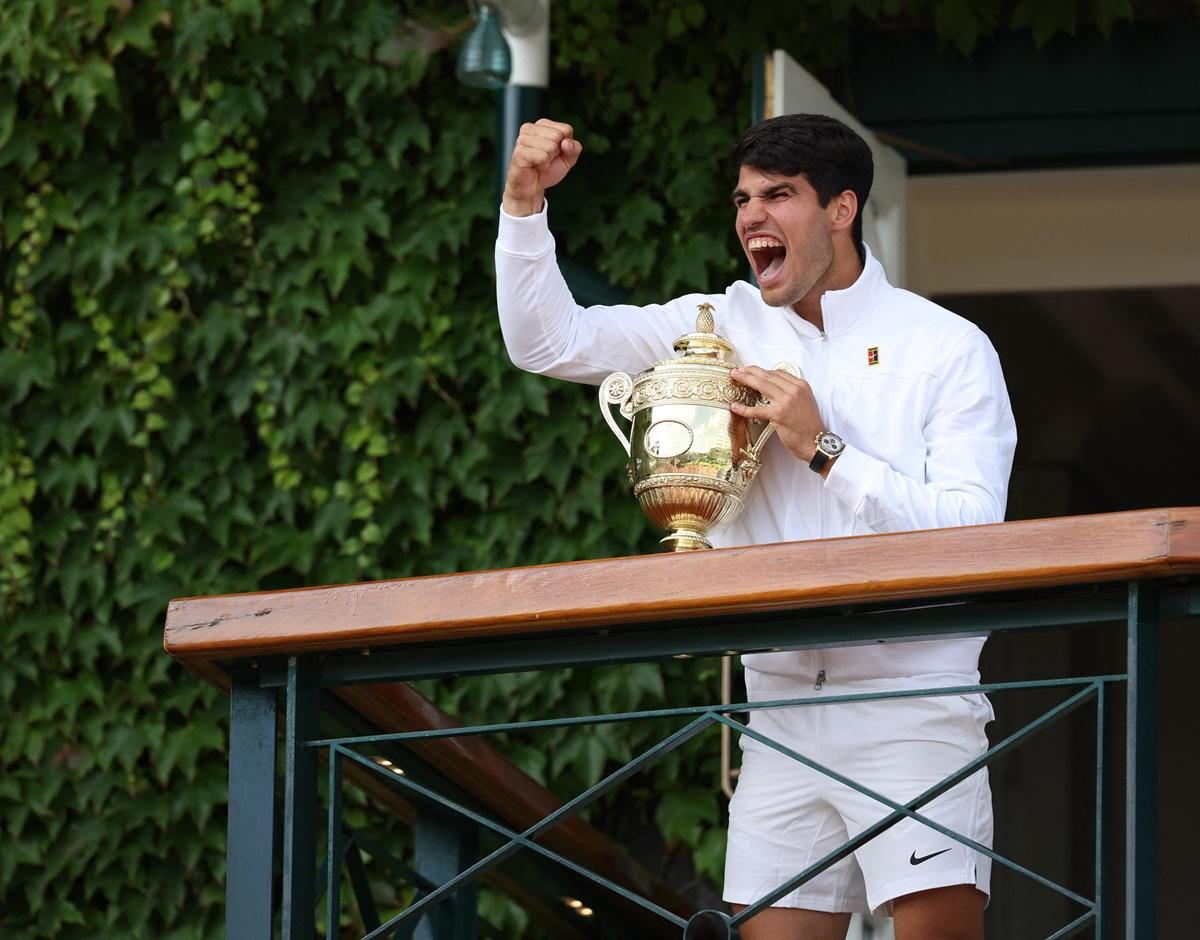 Spain's Carlos Alcaraz celebrates with the trophy on the balcony after winning the men's singles final against Serbia's Novak Djokovic at the Wimbledon Championships in London on Sunday.