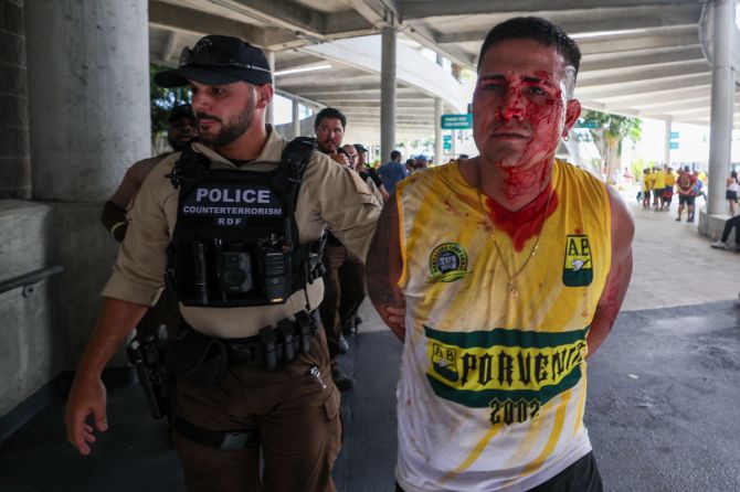 A fan is detained by police before the Copa America Final match between Argentina and Colombia at Hard Rock Stadium in Miami, Florida, on Sunday