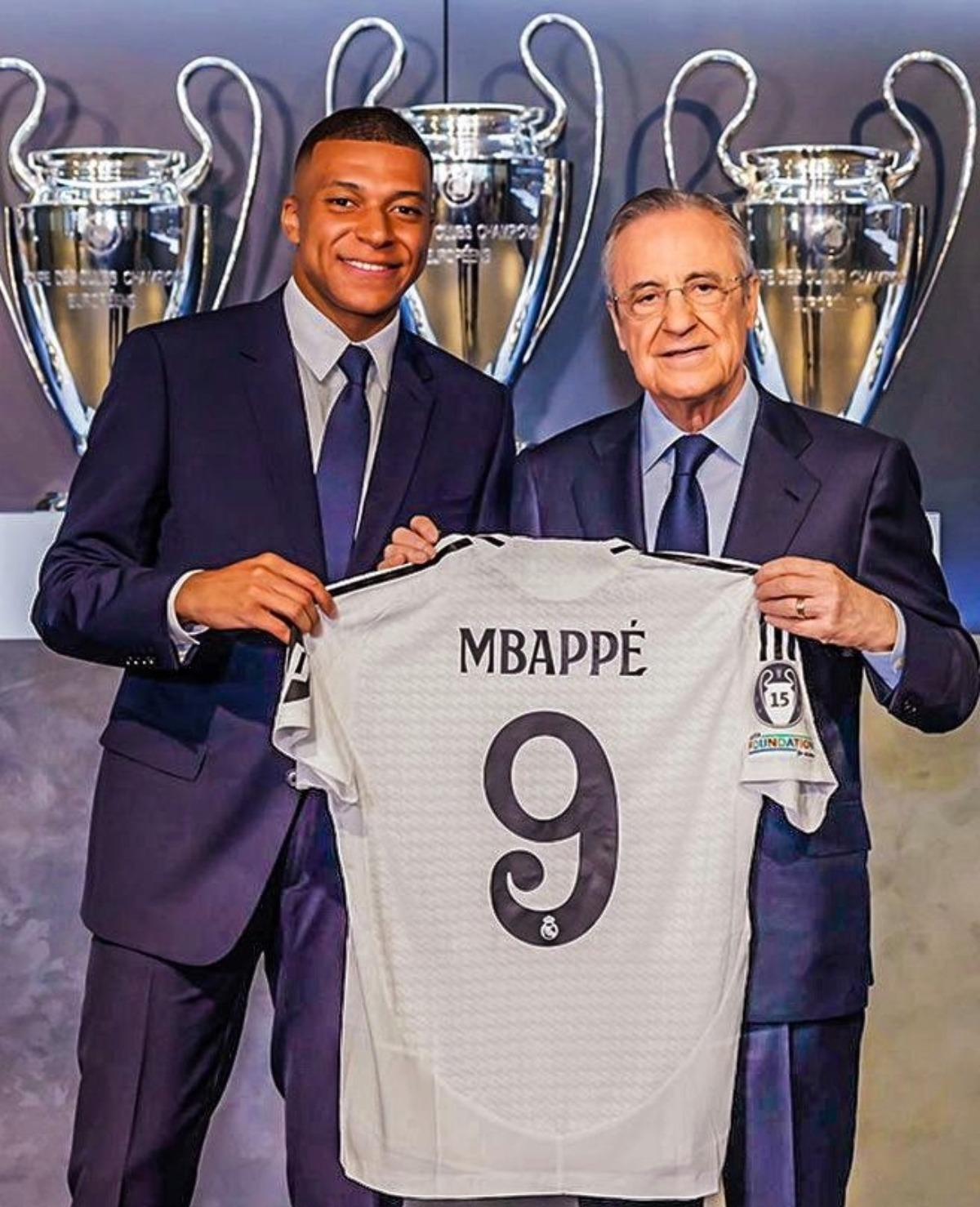 Kylian Mbappe with Real Madrid's president Florentino Perez after signing a five-year contract