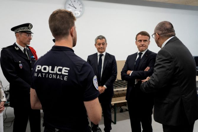  French President Emmanuel Macron and Interior Minister Gerald Darmanin listen to Paris police Prefect Laurent Nunez on a visit to the police station of the Olympic village for the 2024 Summer Olympics, in Paris, France, on Monday, July 22, 2024.