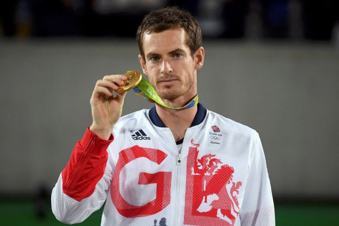 Gold medalist Andy Murray (GBR) of Britain reacts after receiving his medal at the 2016 Rio Olympics.