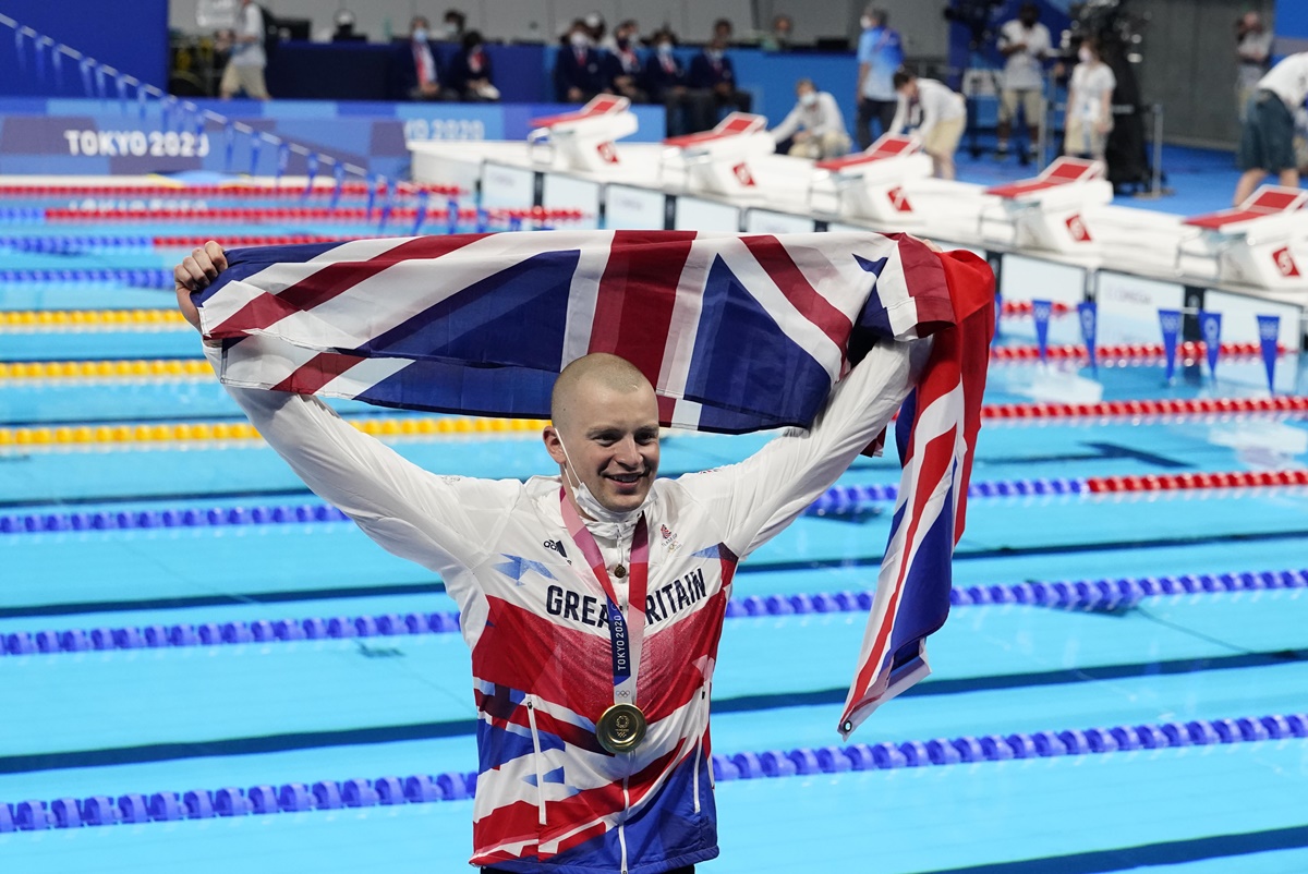 Adam Peaty celebrates with his gold medal during the medals ceremony for the men's 100m breaststroke at the Tokyo 2020 Olympics, at Tokyo Aquatics Centre, Jul 26, 2021.