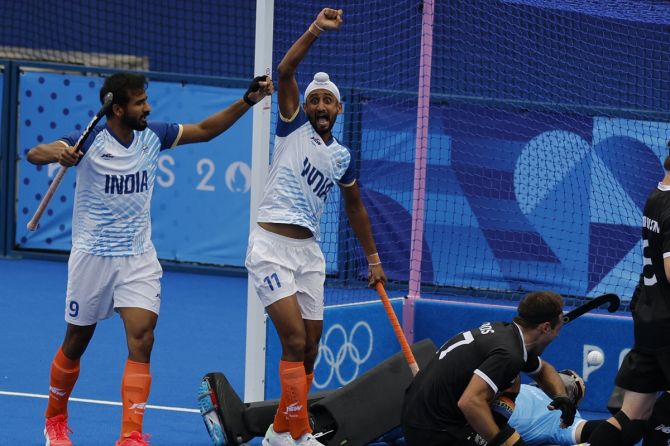 Mandeep Singh celebrates with Gurjant Singh after scoring India's first goal against New Zealand in the Olympics men’s hockey tournament on Saturday