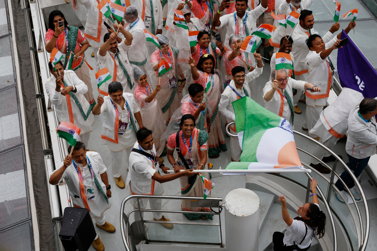 Athletes of India aboard a boat in the floating parade on the river Seine during the opening ceremony.