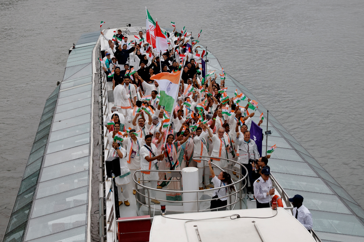 Athletes of India and Iran aboard a boat in the floating parade on the river Seine during the opening ceremony