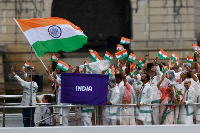 Athletes of India aboard a boat in the floating parade on the river Seine during the opening ceremony