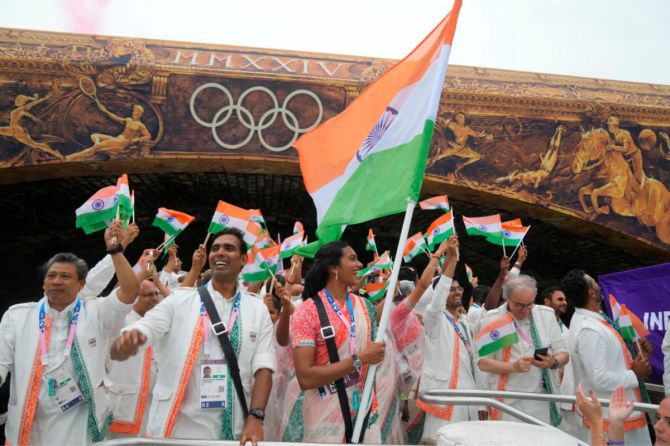 Flag bearers Achanta Sharath Kamal and PV Sindhu  Athletes of India aboard a boat in the floating parade on the river Seine during the opening ceremony