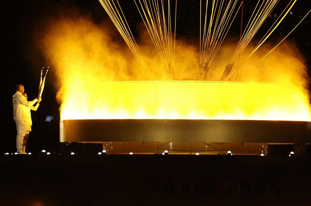 Torchbearers Teddy Riner and Marie-Jose Perec light the Olympic cauldron during the opening ceremony of the Paris 2024 Olympics.