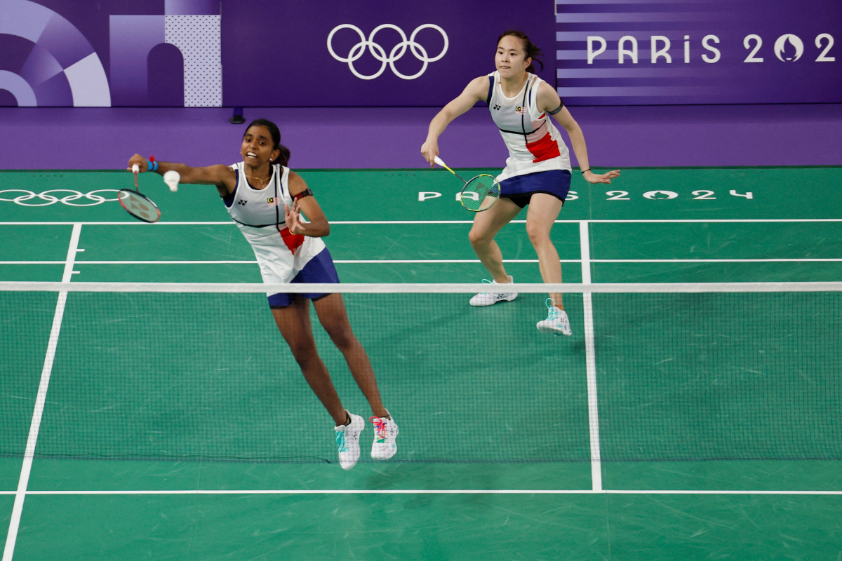 Malaysia's Pearly Tan and Muralitharan Thinaah  in action during the Group A match against China's Qing Chen Chen  and Yi Fan Jia at the Paris 2024 Olympics, Badminton Women's Doubles Group play stage at Porte de La Chapelle Arena, Paris, France, on Saturday