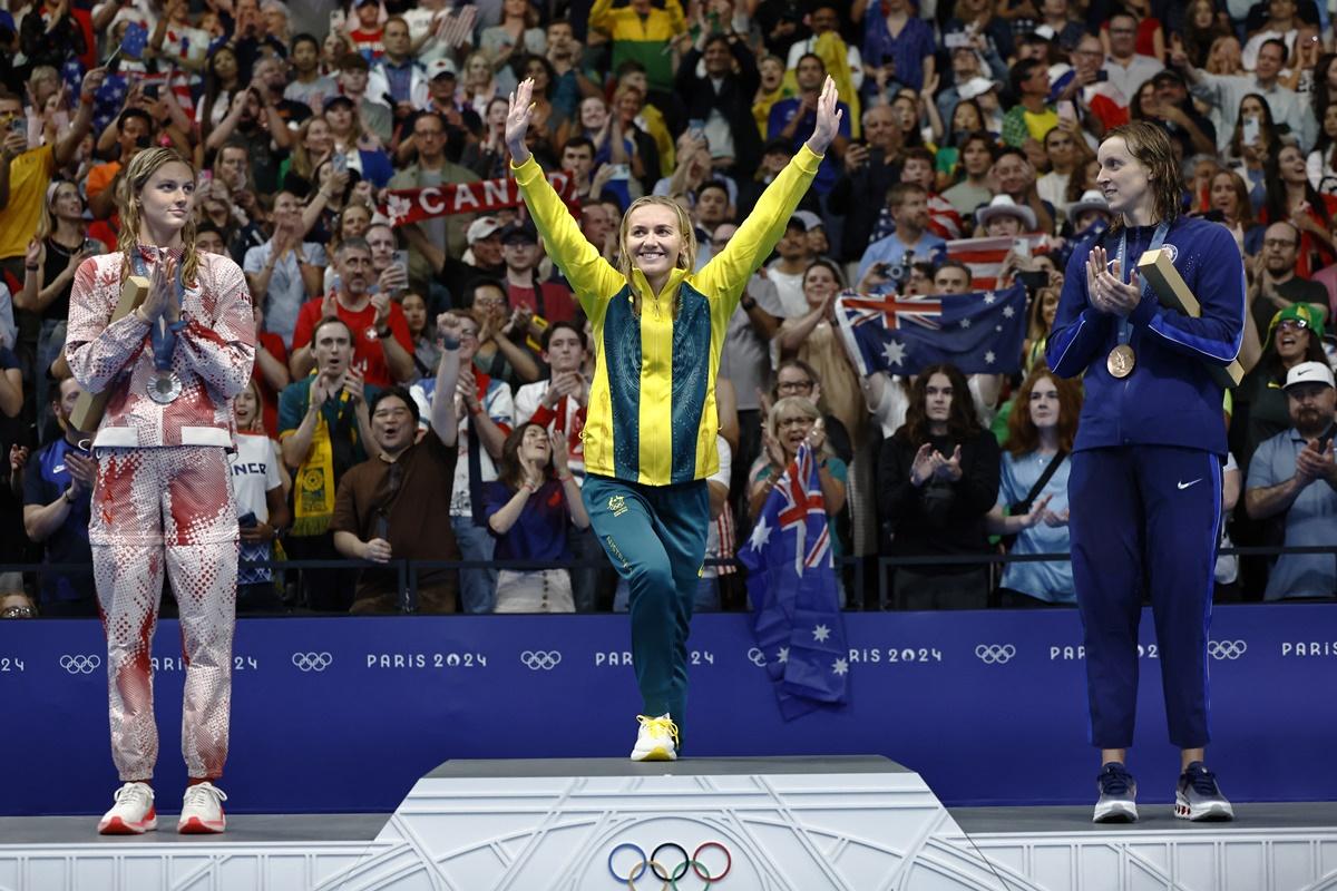 Gold medallist Ariarne Titmus of Australia, silver medallist Summer McIntosh of Canada and bronze medallist Katie Ledecky of United States on the victory stand for the Olympics women's 400m Freestyle victory ceremony, at Paris La Defense Arena, Nanterre, on Saturday.