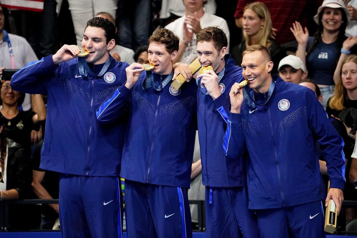 The United States' men’s 4x100 metres freestyle relay team of Jack Alexy, Chris Guiliano, Hunter Armstrong and Caeleb Dressel celebrate with thier medals.