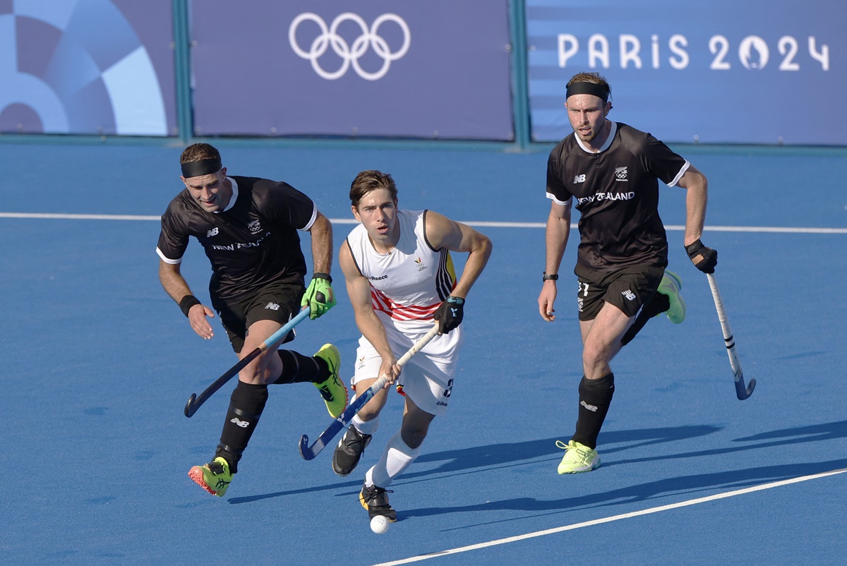 New Zealand's Dane Lett and Hayden Phillips try to check Belgium's Thibeau Stockbroek as he breaks into the circle during the Olympics Hockey men's Pool B match at Yves-du-Manoir Stadium, Colombes, France, on Sunday.