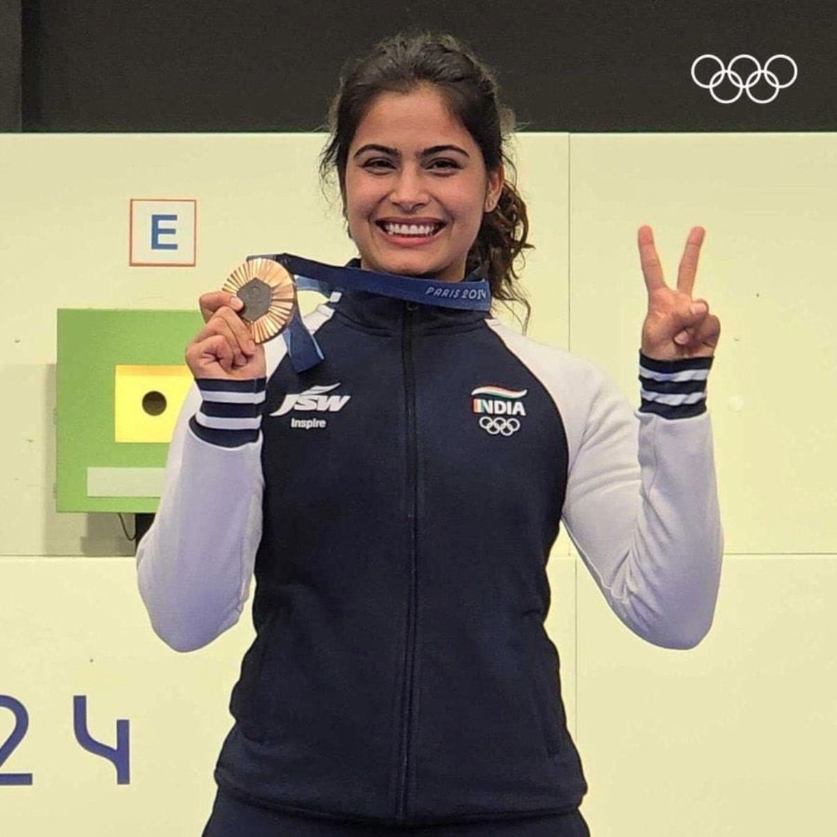Manu Bhaker celebrates after winning the bronze medal in the women's 10m air pistol competition, at the 