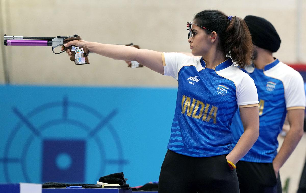 Manu Bhaker of India (L) and Sarabjot Singh of India in action during their bronze medal match in the 10m air pistol mixed team event at the Paris Olympics on Tuesday.